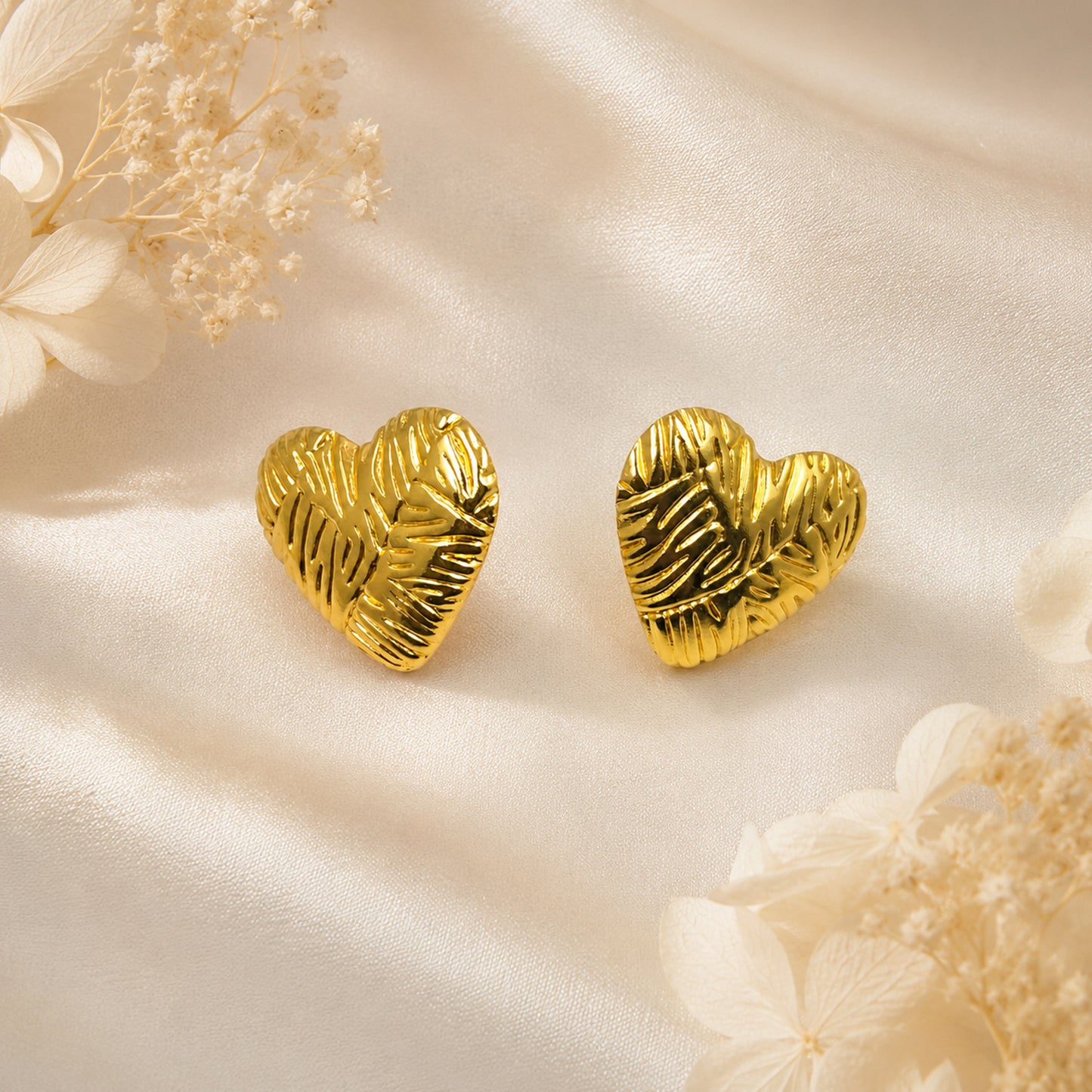 Gold plated heart stud earrings with polished finish