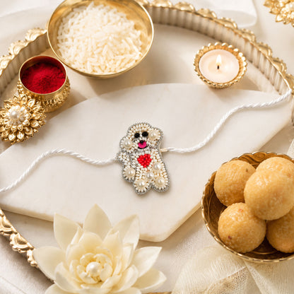 White pearl teddy bear designer rakhi on white