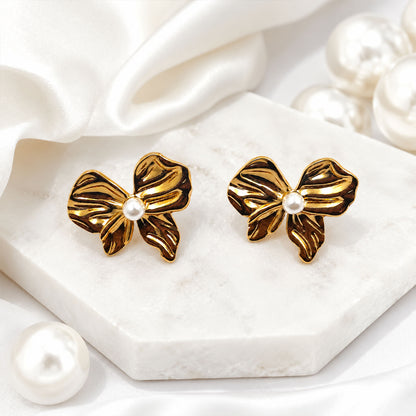 Gold bow stud earrings styled as elegant fashion jewellery
