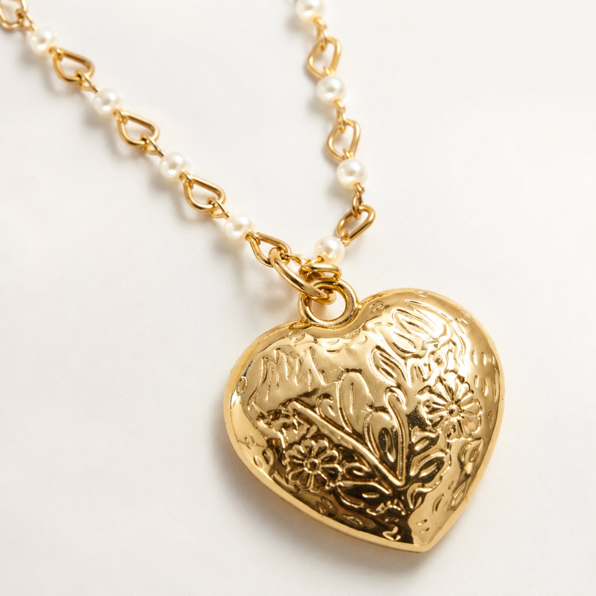 Gold plated heart necklace with pearl-accented chain design