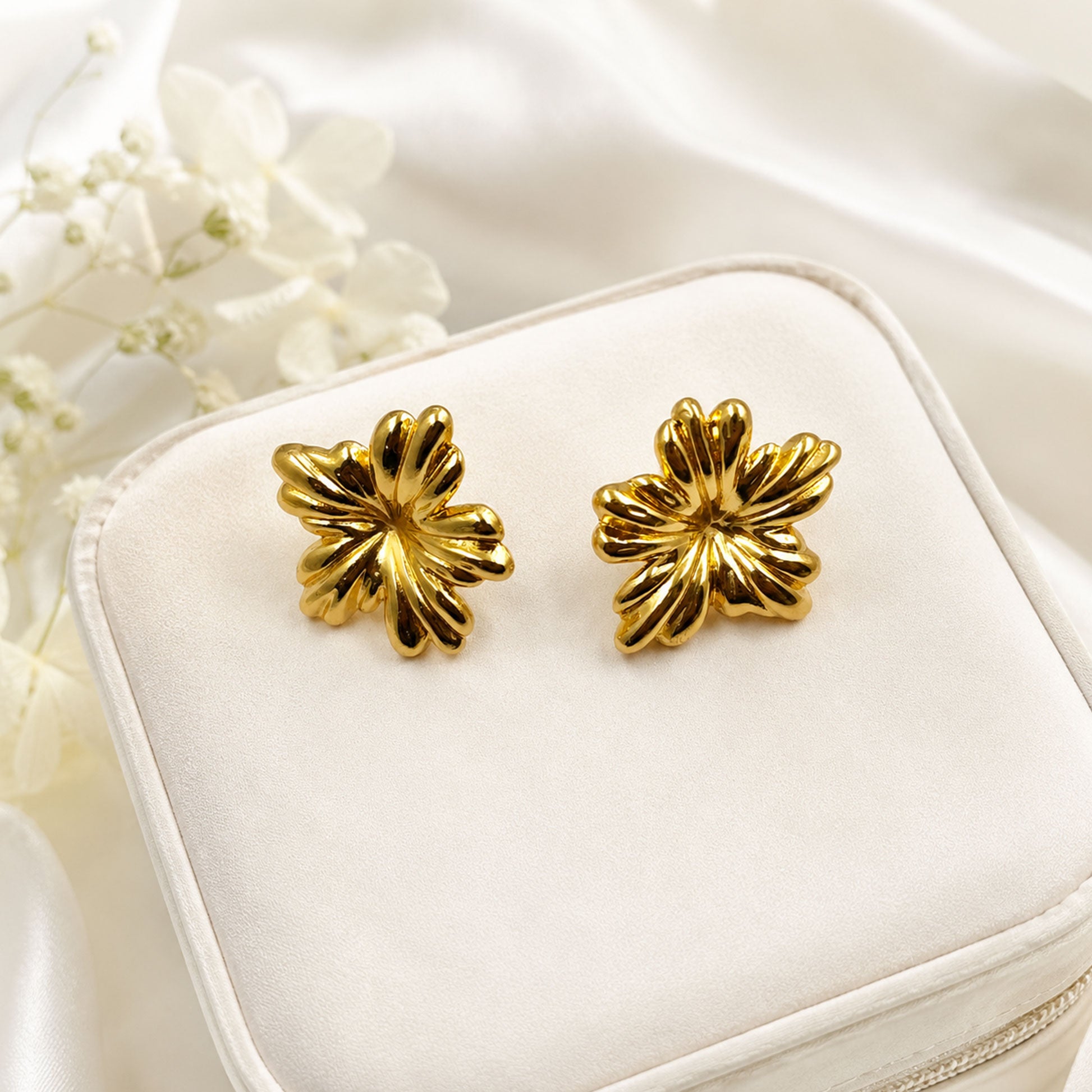 Gold plated floral stud earrings with polished finish