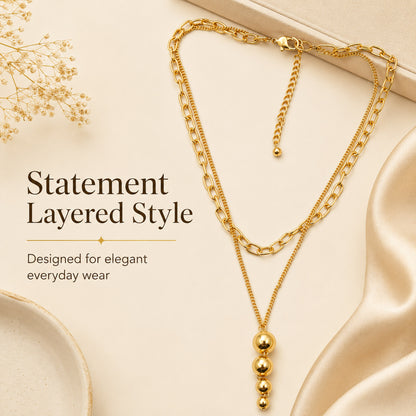 Detailed view of graduated gold ball drop necklace