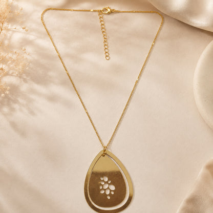 Detailed view of floral cutwork gold pendant necklace