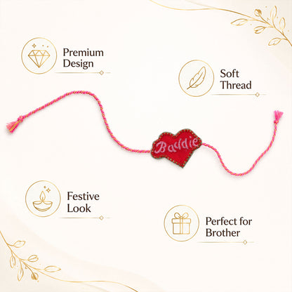 Pink and gold braided thread rakhi with heart centerpiece