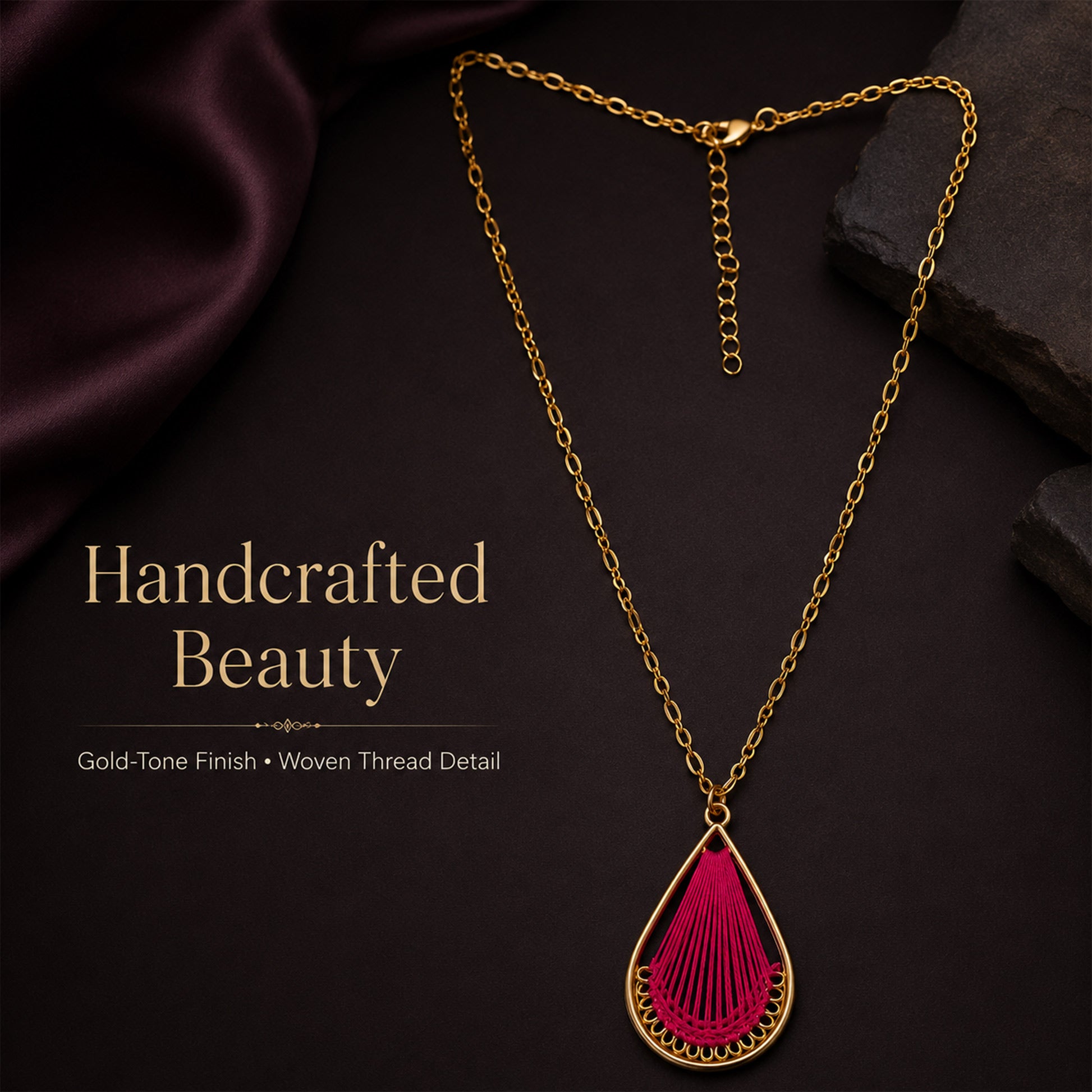 Detailed view of open teardrop pendant with woven pink thread