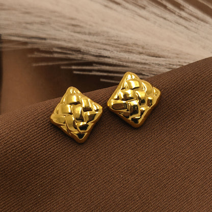 Detailed view of sculpted gold square stud earrings