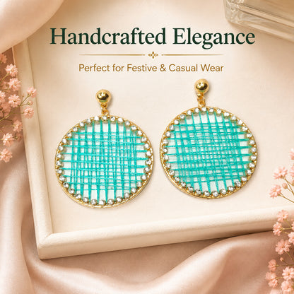 Detailed view of round drop earrings with sparkling stone border