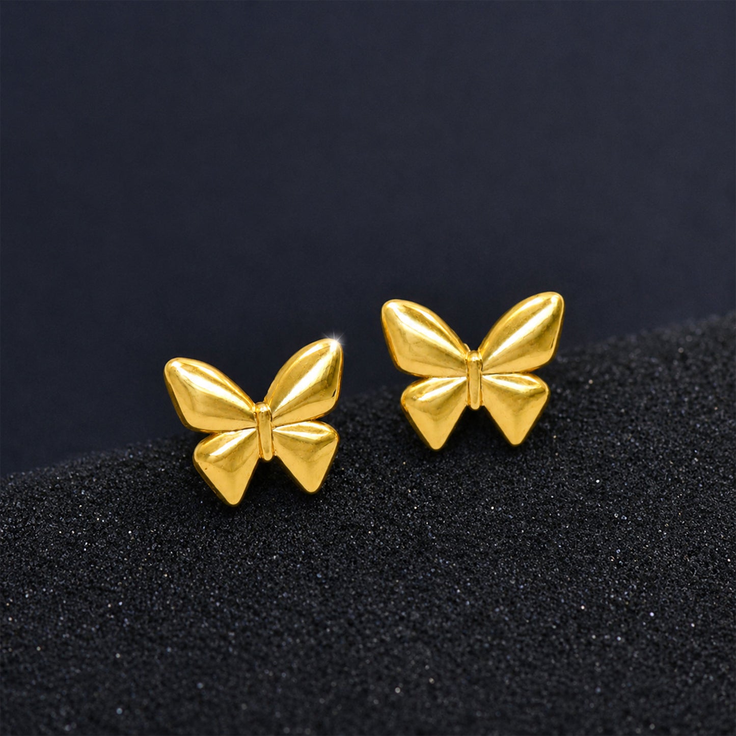 Gold butterfly earrings styled as feminine fashion jewellery