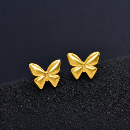 Gold butterfly earrings styled as feminine fashion jewellery