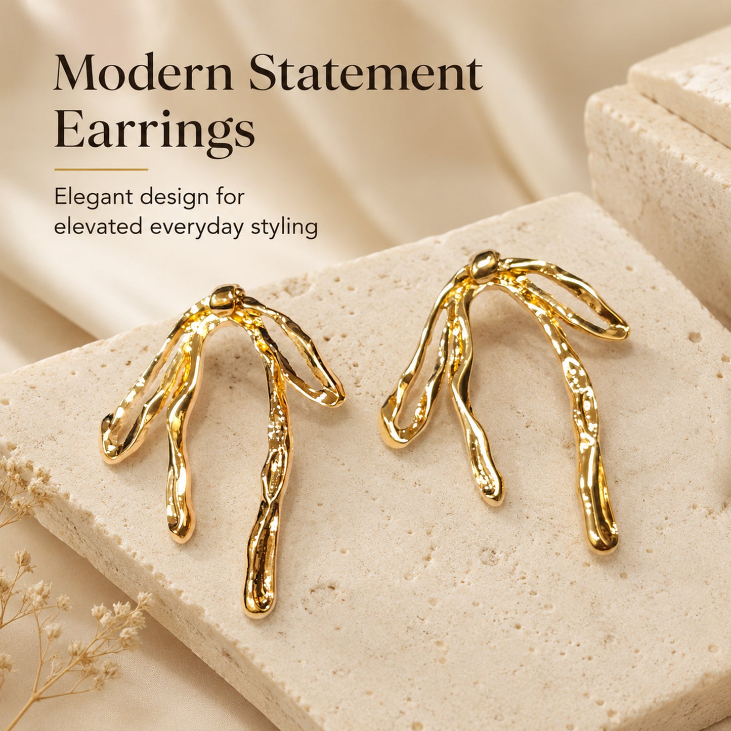 Detailed view of sculptural gold abstract drop earrings