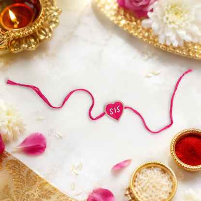Heart-shaped SIS rakhi with decorative pearl design