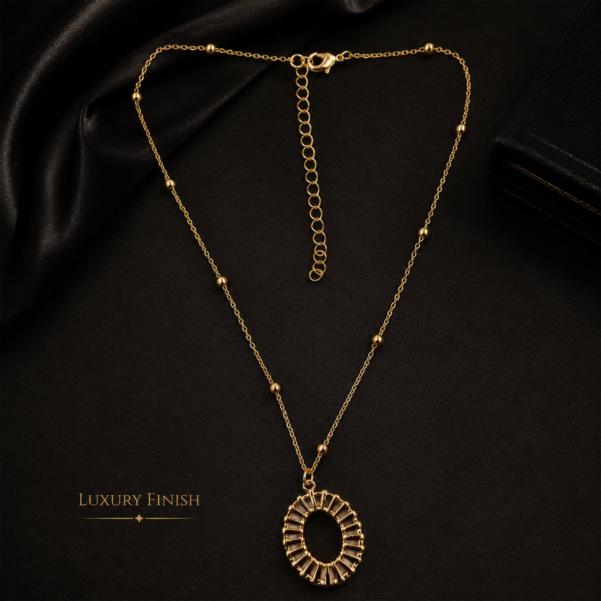 Detailed view of gold sunburst-inspired open pendant necklace