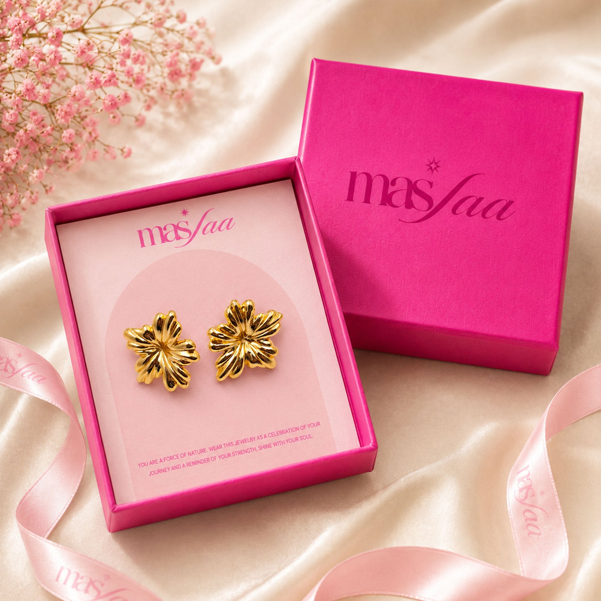 Detailed view of bold gold floral stud earrings