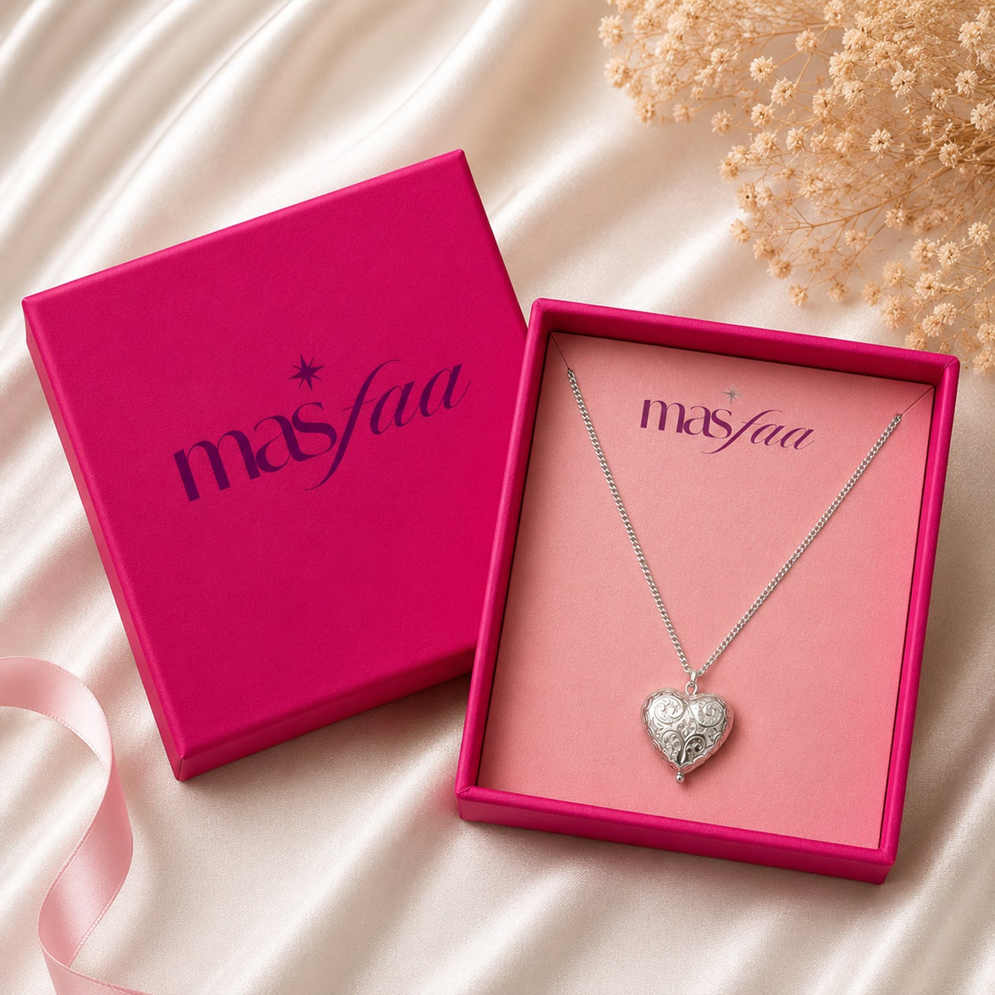 Detailed view of embossed silver heart pendant necklace