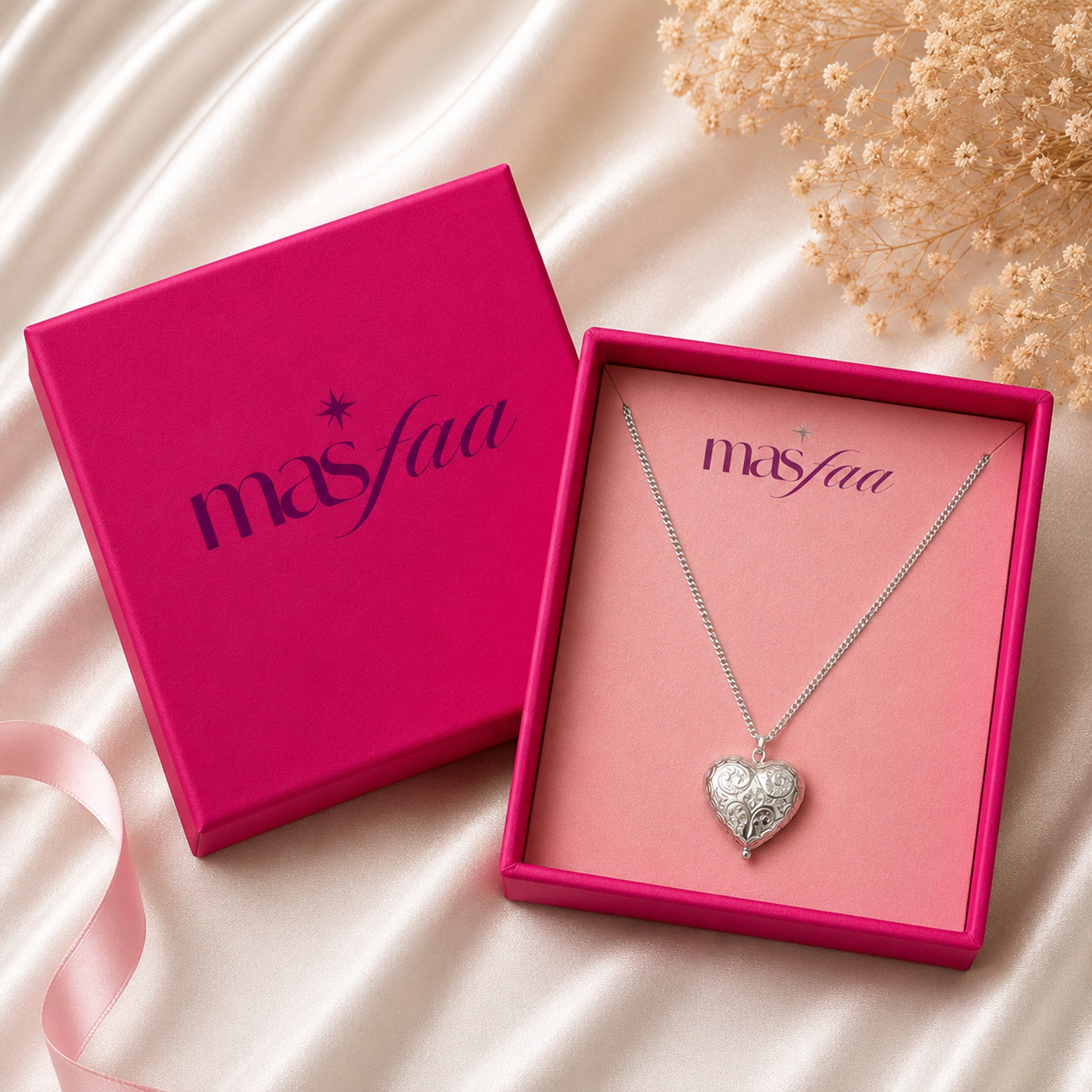 Detailed view of embossed silver heart pendant necklace