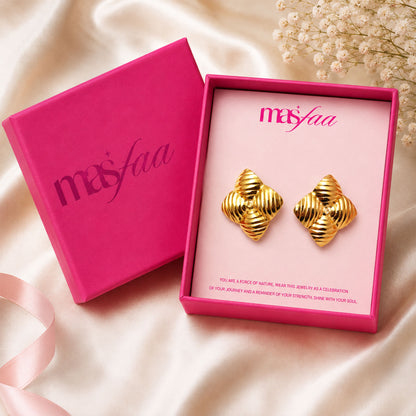 Detailed view of bold gold star stud earrings