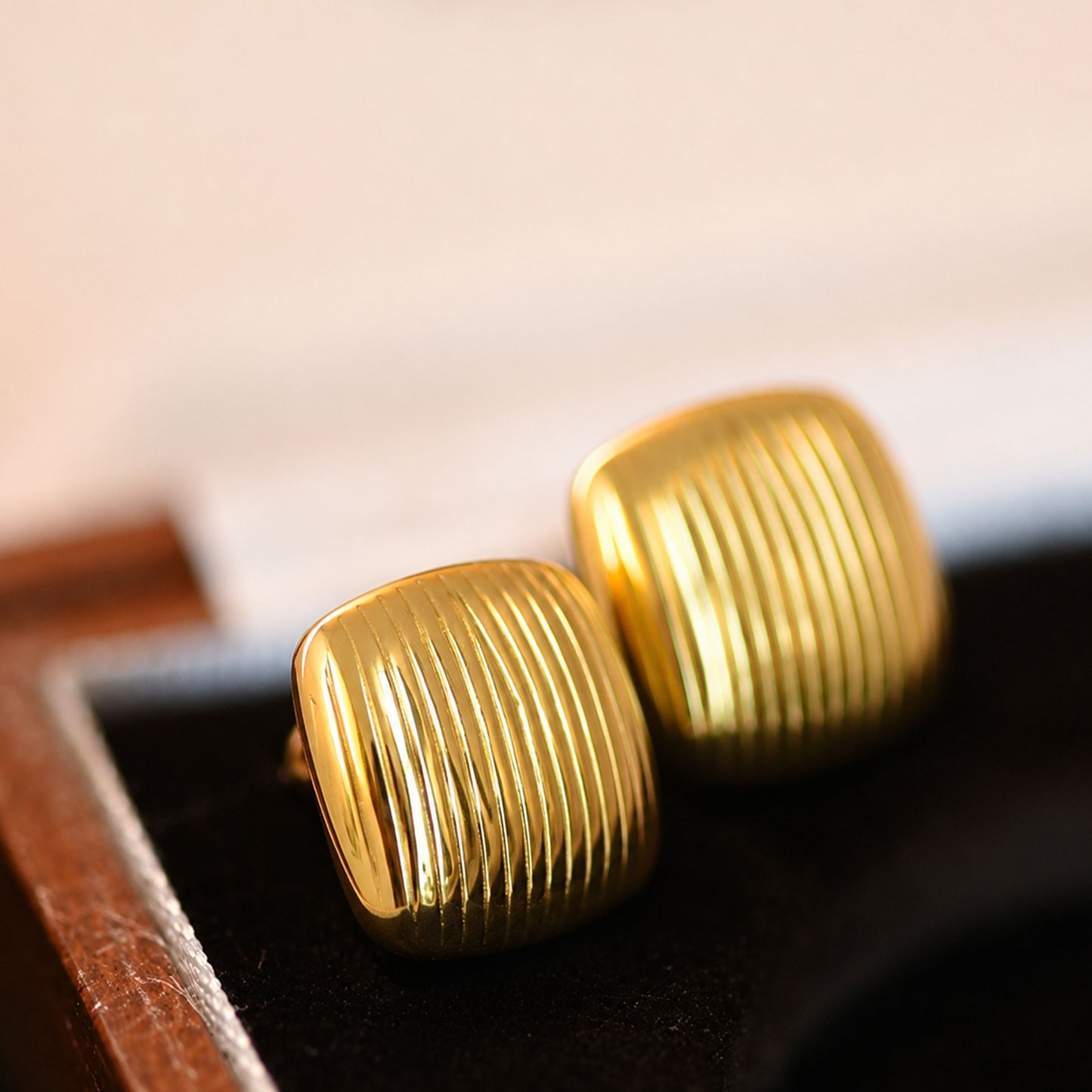 Gold square stud earrings styled as modern fashion jewellery for women