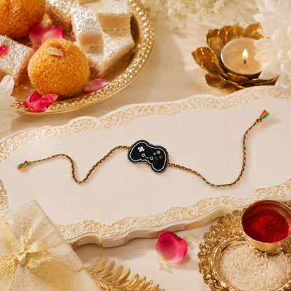 Multicolor braided thread rakhi with game controller centerpiece