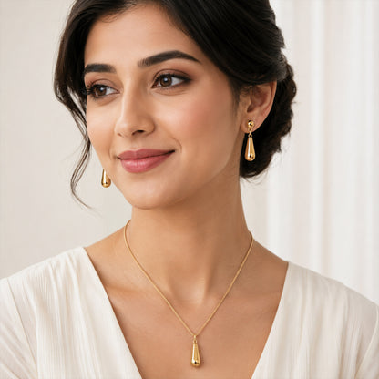 Close-up view of gold teardrop necklace with smooth finish