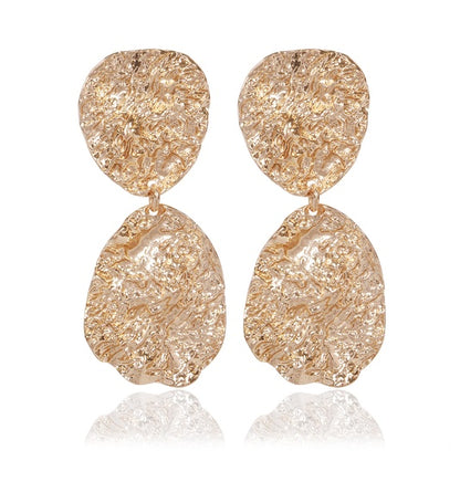 Rose gold textured teardrop drop earrings pair on white background