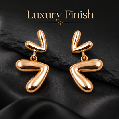 Detailed view of modern abstract rose gold drop earrings