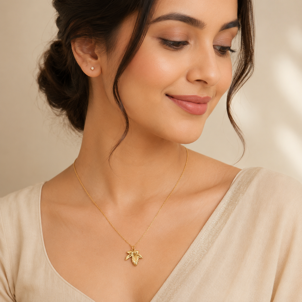 Detailed view of nature-inspired gold pendant necklace