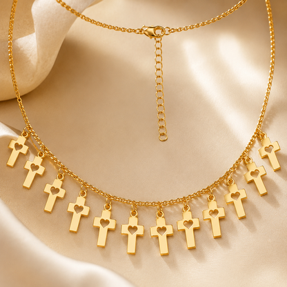Detailed view of gold cross charms with heart cutout design