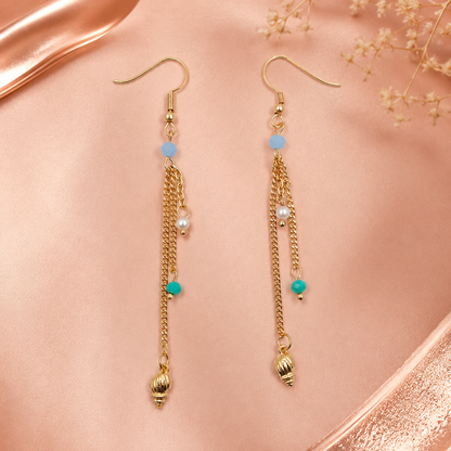 Gold beach-inspired earrings styled as fashion jewellery