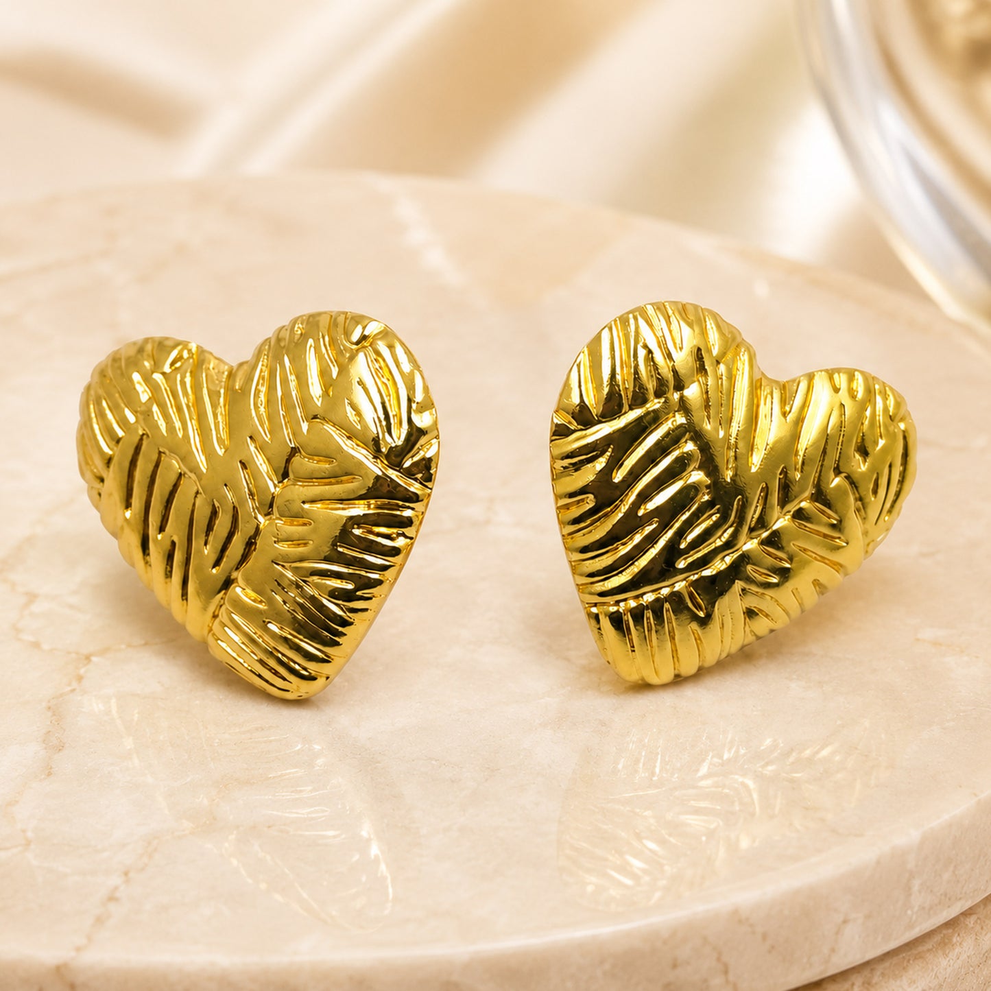 Gold heart earrings styled as romantic fashion jewellery for women