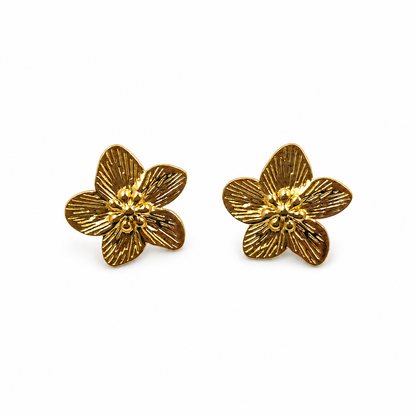 Gold textured flower stud earrings pair on white background