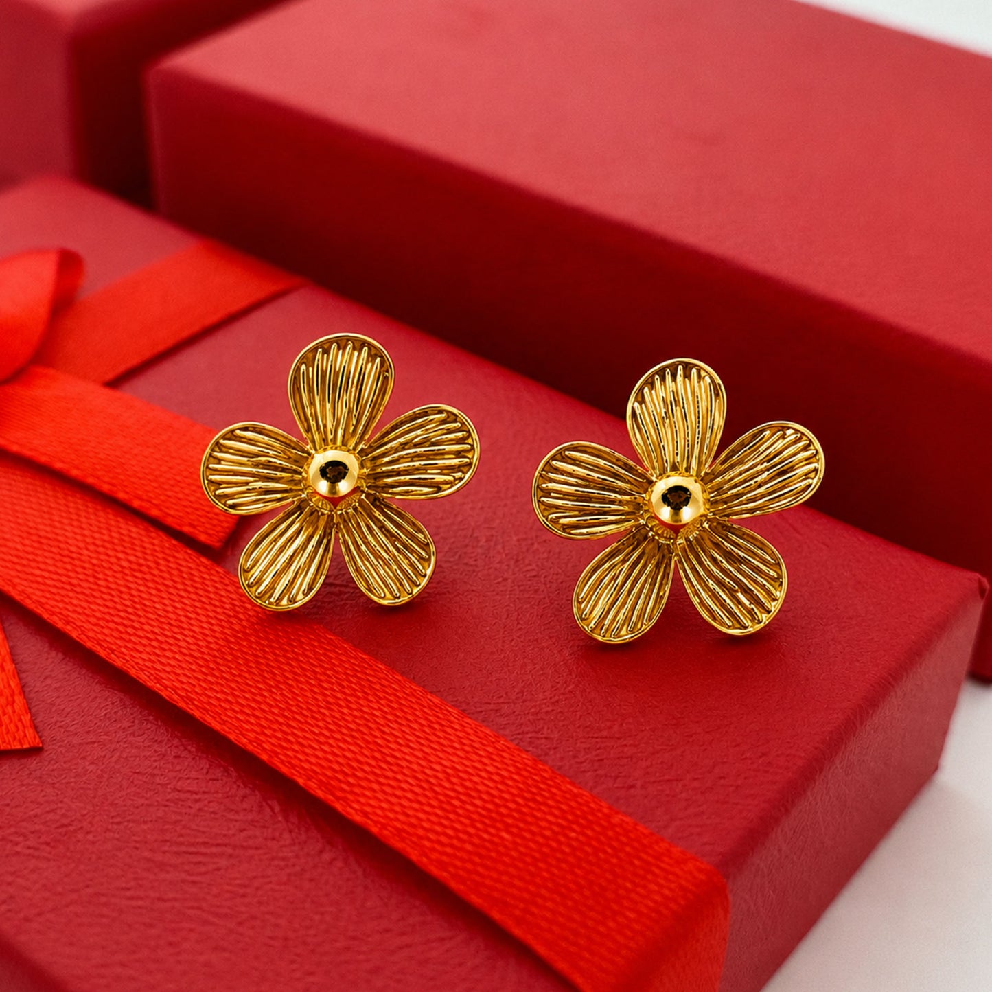Detailed view of ribbed petal gold flower stud earrings