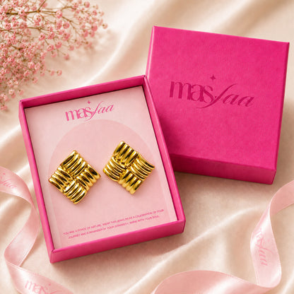 Close-up view of gold ribbed knot earrings with polished finish with box
