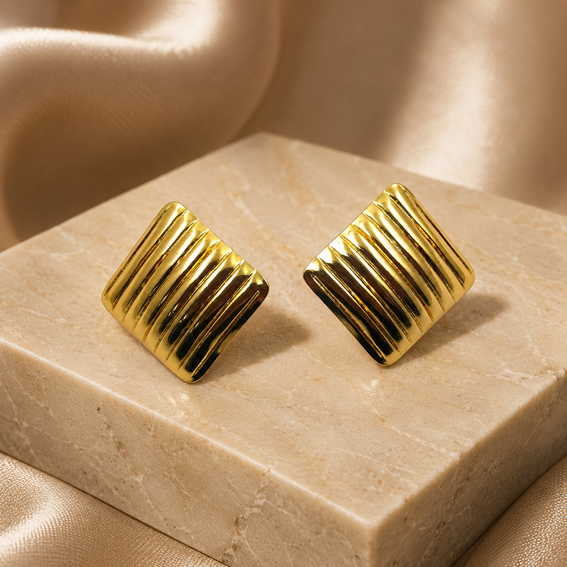 Gold ribbed square earrings styled with modern fashion outfit