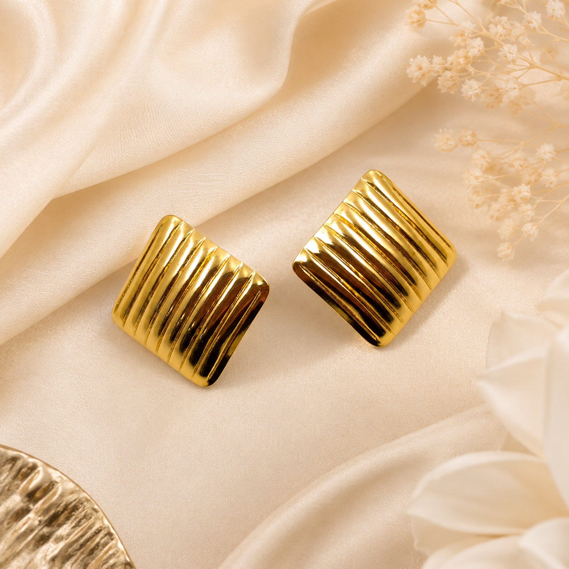 Gold ribbed square earrings styled with modern fashion outfit