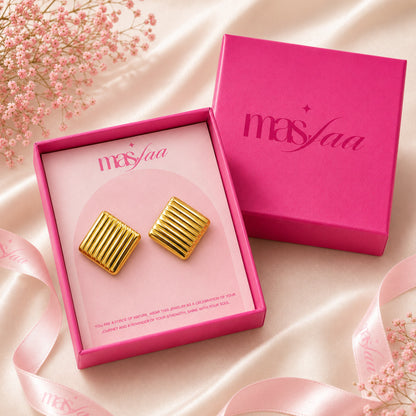 Gold square stud earrings placed in premium jewellery gift box