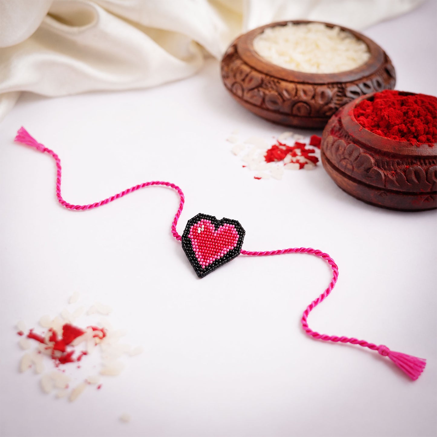 Cute heart design rakhi with bright pink braided thread