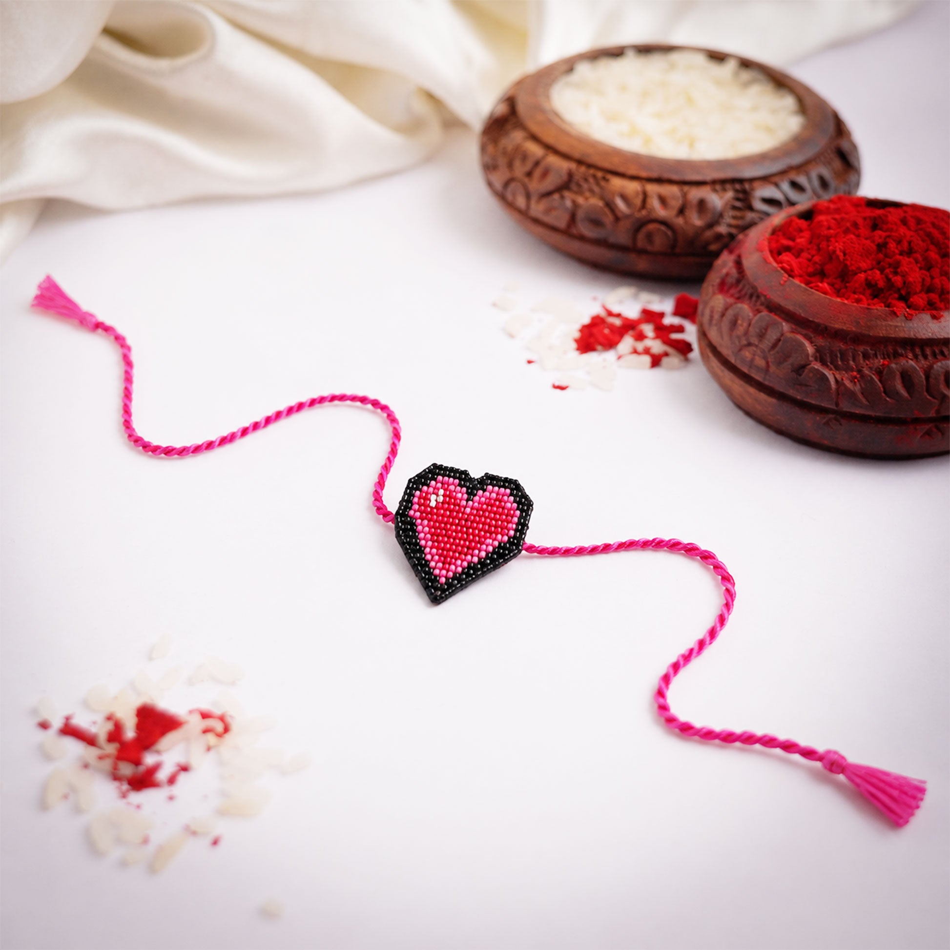 Cute heart design rakhi with bright pink braided thread