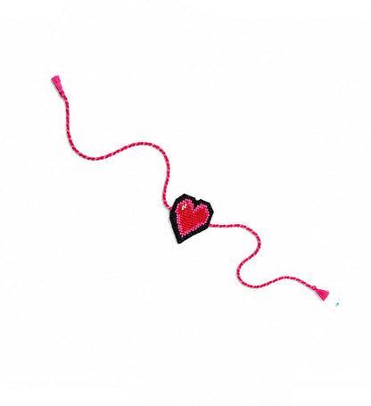 Pink heart beaded rakhi on white background
