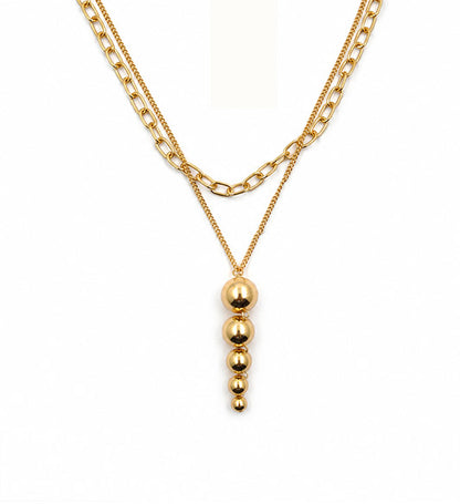 Gold layered graduated bead pendant necklace on white background