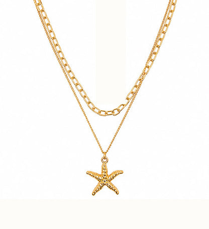Gold layered starfish pendant necklace on white background