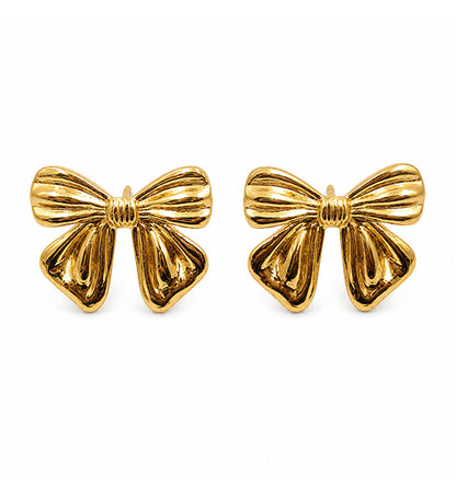 Gold bow stud earrings pair on white background