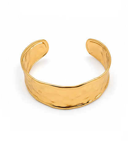 Gold hammered open cuff bracelet on white background