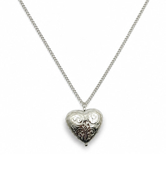Silver engraved heart pendant necklace on white background