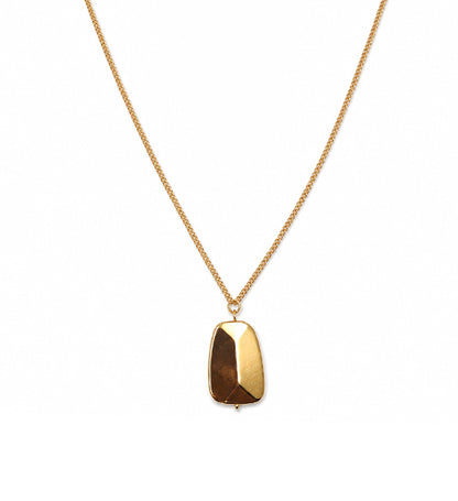 Gold geometric pendant necklace on white background