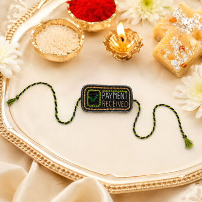 Black and green braided thread rakhi with payment received centerpiece